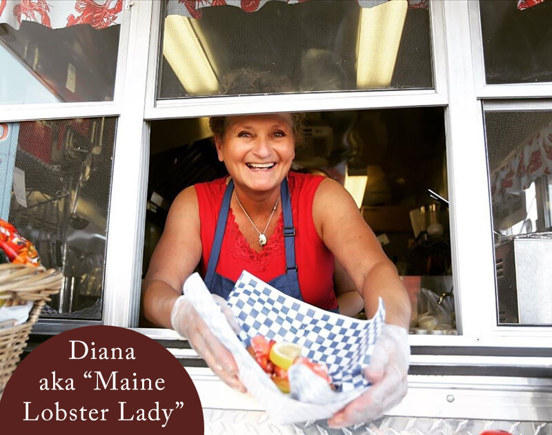 Diana, aka The Maine Lobster Lady, serving a lobster roll out of the food truck
