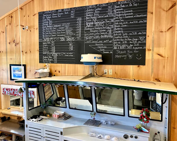 A lobster boat was cut in half and serves as the window between the kitchen and counter area